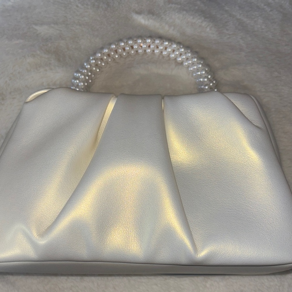 Chic White Bag with Beaded Handle and Voluminous Shape